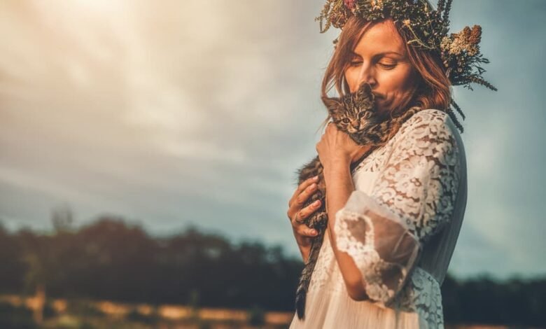 Woman with floral crown with kitten