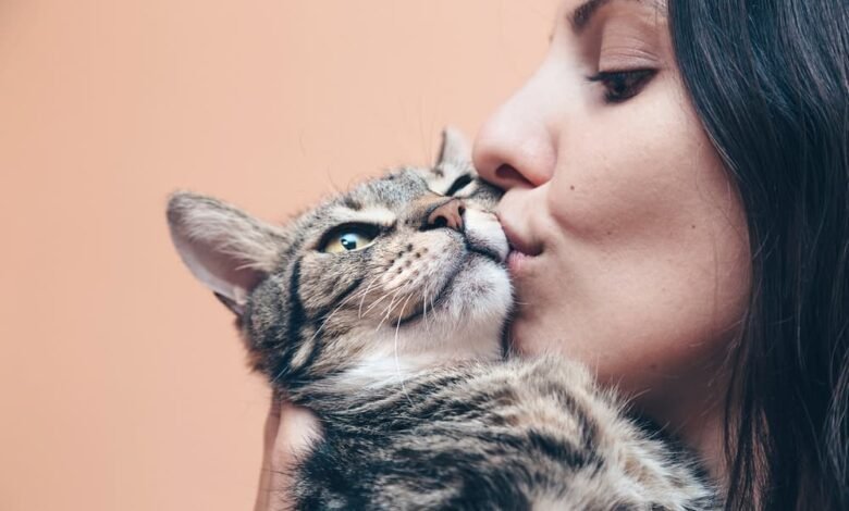 Woman kissing her cat